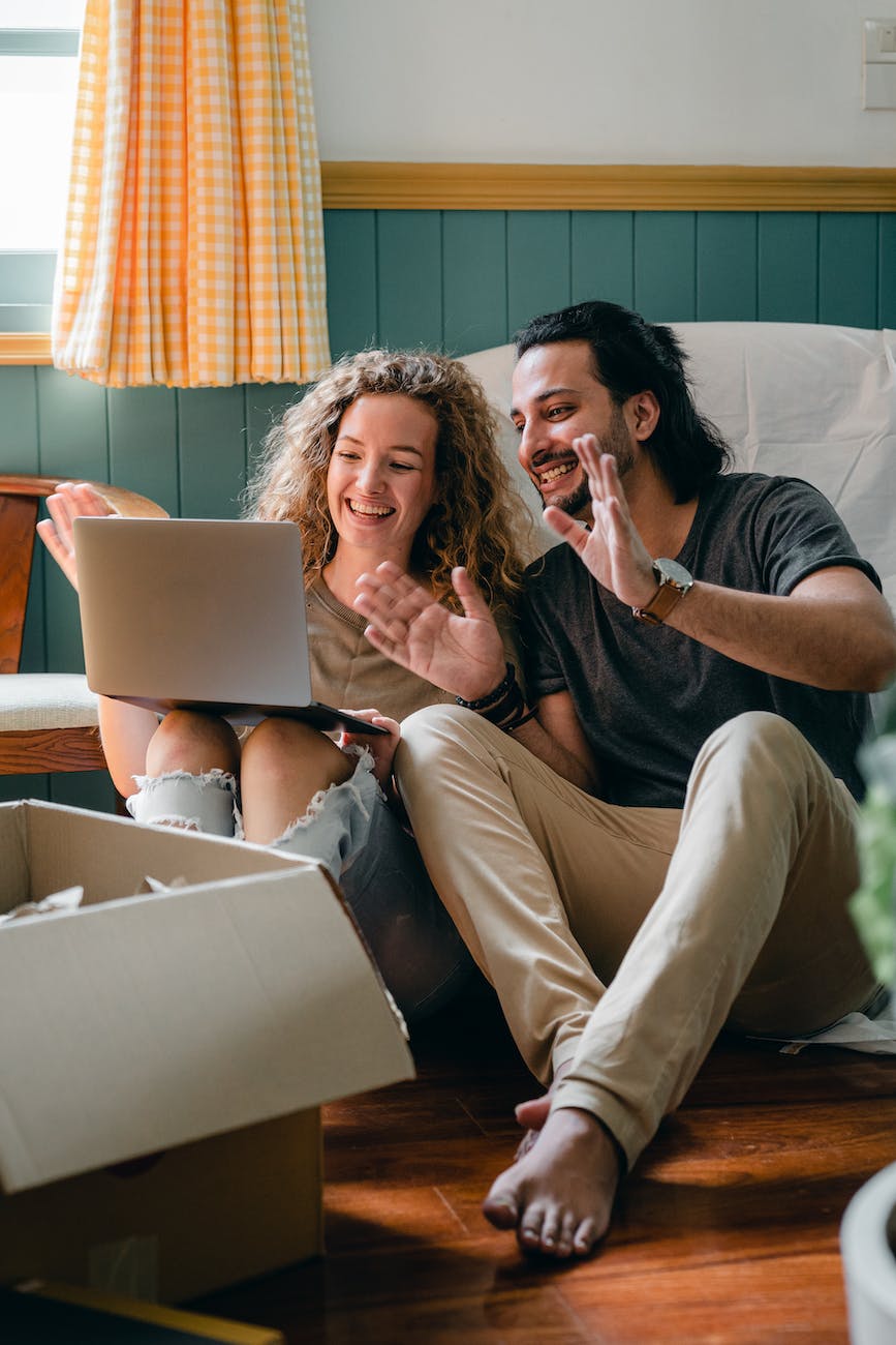 cheerful couple having video chat via laptop