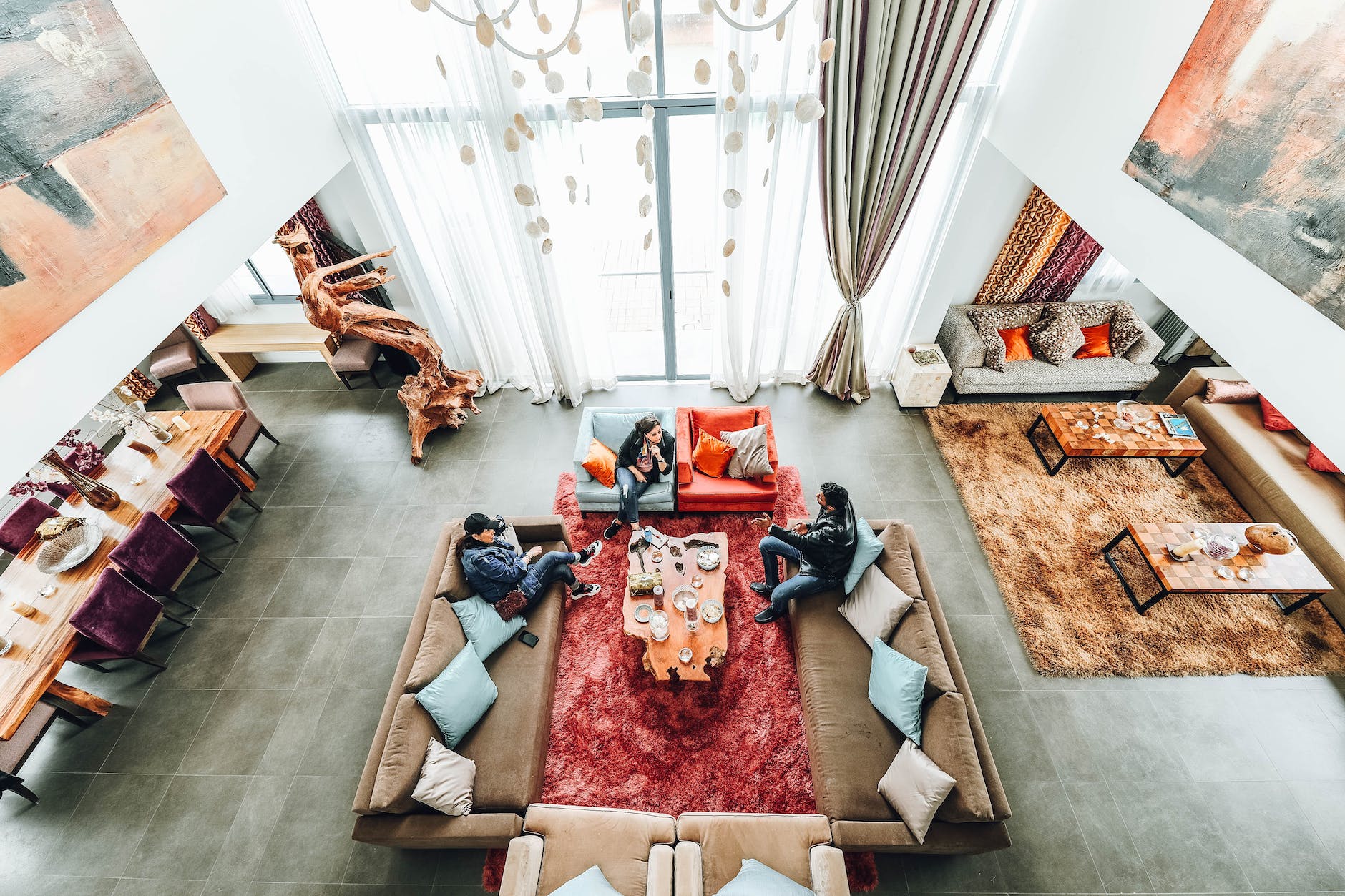 aerial photography of three people sitting on sofa